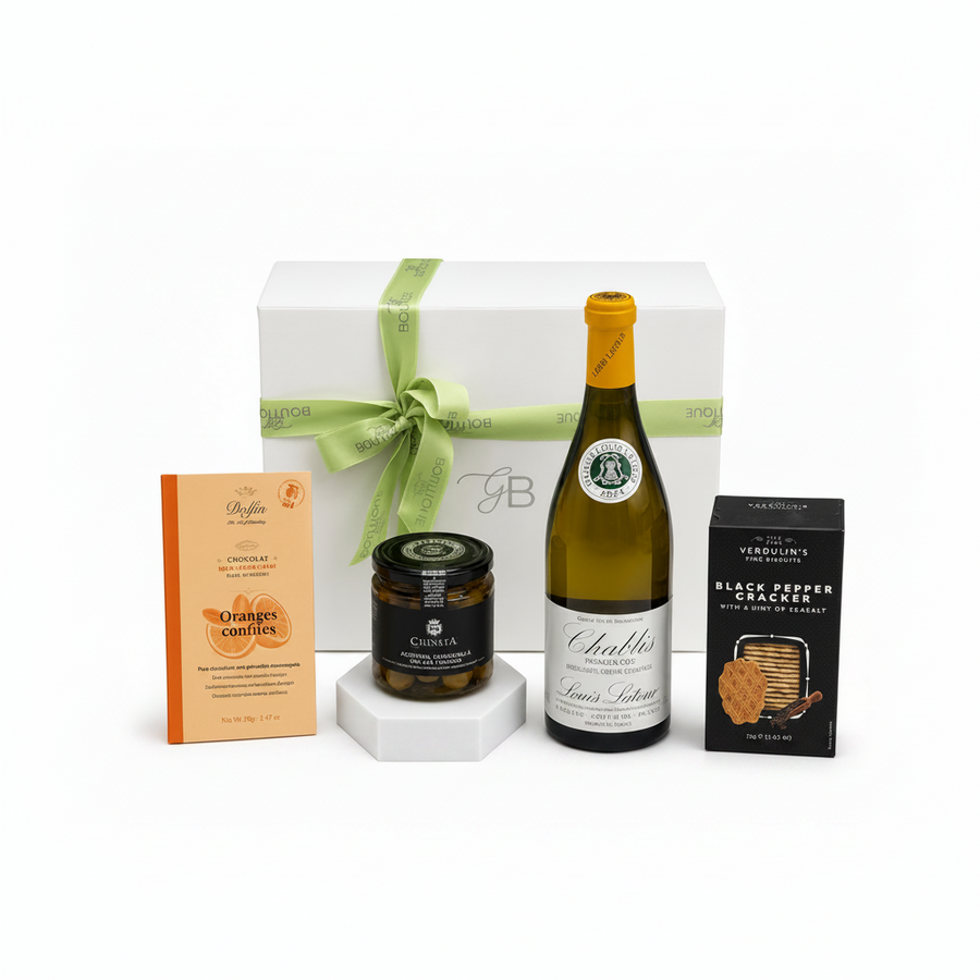 Wine bottle with a gift box, olives and  snacks on a white gift box