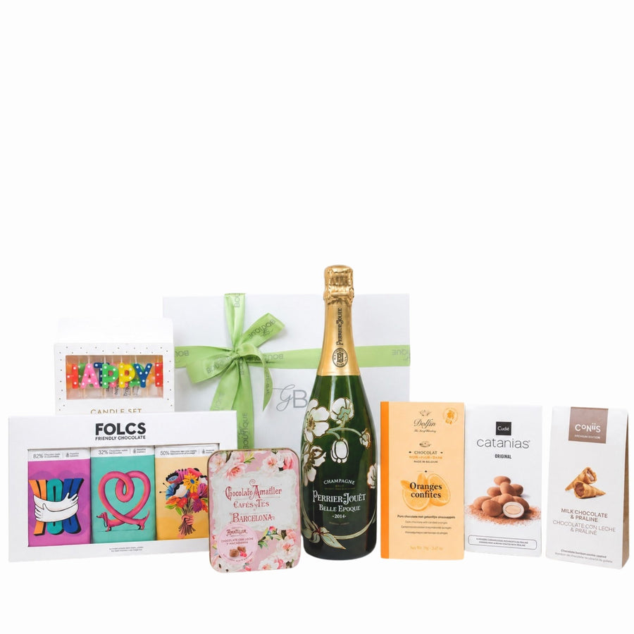 Gift set with champagne bottle, candies, and other items on a white background
